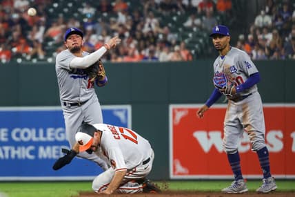 Jul 17, 2023; Baltimore, Maryland, USA;  Los Angeles Dodgers shortstop Miguel Rojas (11) throws to first base over a sliding Baltimore Orioles outfielder Colton Cowser (17) as second baseman Mookie Betts (50) looks on in the ninth inning at Oriole Park at Camden Yards. Mandatory Credit: Tommy Gilligan-USA TODAY Sports