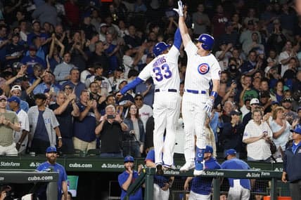 Jul 18, 2023; Chicago, Illinois, USA; Chicago Cubs third baseman Patrick Wisdom (16) is greeted by Chicago Cubs third base coach Willie Harris (33) after hitting a home run against the Washington Nationals during the seventh inning at Wrigley Field. Mandatory Credit: David Banks-USA TODAY Sports