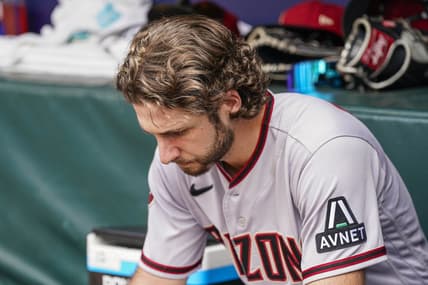 Jul 20, 2023; Cumberland, Georgia, USA; Arizona Diamondbacks starting pitcher Zac Gallen (23) studies a tablet in the dugout against the Atlanta Braves during the second inning at Truist Park. Mandatory Credit: Dale Zanine-USA TODAY Sports