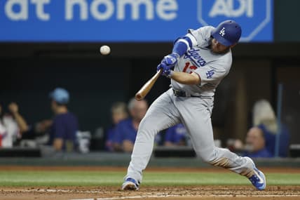 Jul 22, 2023; Arlington, Texas, USA; Los Angeles Dodgers third baseman Max Muncy (13) hits a home run against the Texas Rangers in the third inning at Globe Life Field. Mandatory Credit: Tim Heitman-USA TODAY Sports