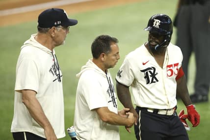 Jul 22, 2023; Arlington, Texas, USA; Texas Rangers right fielder Adolis Garcia (53) is attended to by head trainer Matt Lucero and manager Bruce Bochy (left) after being hit by a pitch in the fourth inning against the Los Angeles Dodgers at Globe Life Field. Mandatory Credit: Tim Heitman-USA TODAY Sports
