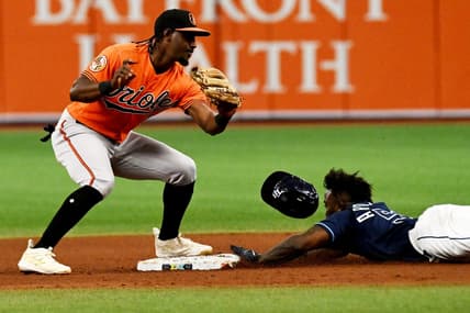 Jul 22, 2023; St. Petersburg, Florida, USA; Tampa Bay Rays left fielder Randy Arozarena (56) lies as Baltimore Orioles short stop Jorge Mateo (3) attempts to place the tag in the eighth inning at Tropicana Field. Mandatory Credit: Jonathan Dyer-USA TODAY Sports