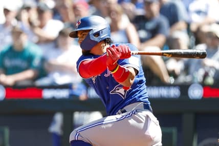 Jul 23, 2023; Seattle, Washington, USA; Toronto Blue Jays second baseman Santiago Espinal (5) hits an RBI-single against the Seattle Mariners during the seventh inning at T-Mobile Park. Mandatory Credit: Joe Nicholson-USA TODAY Sports