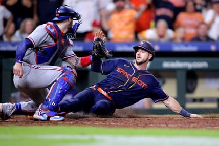 Jul 24, 2023; Houston, Texas, USA; Houston Astros right fielder Kyle Tucker (30) slides into home plate to score the game winning run while beating the tag of Texas Rangers catcher Jonah Heim (28) during the ninth inning at Minute Maid Park. Mandatory Credit: Erik Williams-USA TODAY Sports