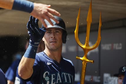 Jul 26, 2023; Minneapolis, Minnesota, USA; Seattle Mariners shortstop Dylan Moore (25) celebrates his solo home run with teammates in the dugout against the Minnesota Twins in the second inning at Target Field. Mandatory Credit: Bruce Kluckhohn-USA TODAY Sports