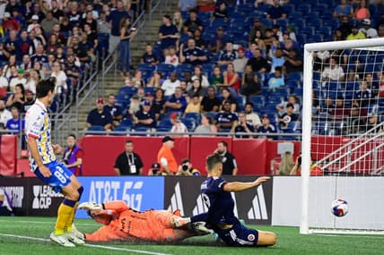 Jul 26, 2023; Foxborough, MA, USA; New England Revolution forward Giacomo Vrioni (9) scores a goal on Club Atletico de San Luis goalkeeper Andres Sanchez (1)  during the second half at Gillette Stadium. Mandatory Credit: Eric Canha-USA TODAY Sports