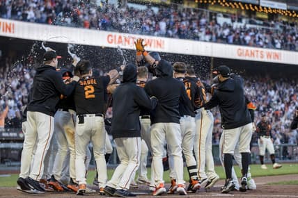 Jul 29, 2023; San Francisco, California, USA;  San Francisco Giants third baseman J.D. Davis (7) celebrates with teammates after hitting a solo home run during the ninth inning to defeat the Boston Red Sox at Oracle Park. Mandatory Credit: John Hefti-USA TODAY Sports