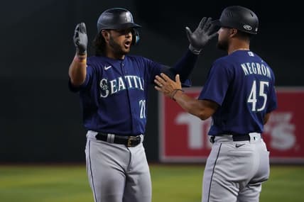 Jul 30, 2023; Phoenix, Arizona, USA; Seattle Mariners third baseman Eugenio Suarez (28) celebrates with Seattle Mariners first base coach Kristopher Negr  n (45) after hitting an RBI single against the Arizona Diamondbacks during the ninth inning at Chase Field. Mandatory Credit: Joe Camporeale-USA TODAY Sports