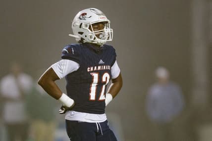 Chaminade-Madonna's Zaquan Patterson (12) walks off the field to meet with his team during a timeout. Chaminade-Madonna shutout Berkeley Prep 21-0 to claim the 3A State Championship title at Gene Cox Stadium on Friday, Dec. 10, 2021.

Second Half Chaminade Madonna V Bp 021