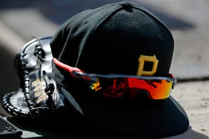 Apr 23, 2022; Chicago, Illinois, USA; A detail view of the glove, hat, and sunglasses of Pittsburgh Pirates first baseman Yoshi Tsutsugo (not pictured) during the eighth inning of their game against the Chicago Cubs at Wrigley Field. Mandatory Credit: Jon Durr-USA TODAY Sports