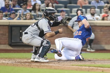Jul 19, 2023; New York City, New York, USA;  New York Mets third baseman Brett Baty (22) slides safely past Chicago White Sox catcher Carlos Perez (36) in the fourth inning at Citi Field. Mandatory Credit: Wendell Cruz-USA TODAY Sports
