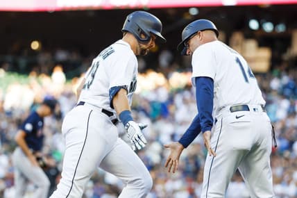 Jul 31, 2023; Seattle, Washington, USA; Seattle Mariners catcher Cal Raleigh (29) receives a greeting from third base coach Manny Acta (14) while running the bases following a solo-home run against the Boston Red Sox during the second inning at T-Mobile Park. Mandatory Credit: Joe Nicholson-USA TODAY Sports