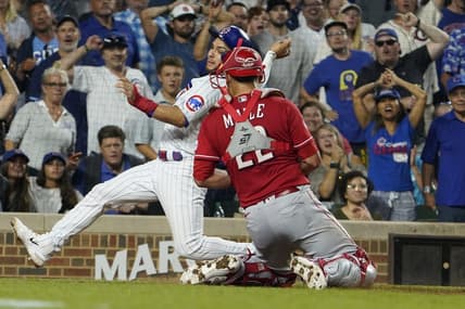 Aug 3, 2023; Chicago, Illinois, USA; Cincinnati Reds catcher Luke Maile (22) tags out Chicago Cubs third baseman Nick Madrigal (1) during the fourth inning at Wrigley Field. Mandatory Credit: David Banks-USA TODAY Sports
