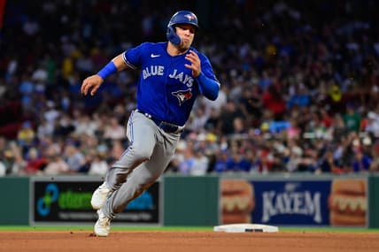 Aug 4, 2023; Boston, Massachusetts, USA; Toronto Blue Jays center fielder Daulton Varsho (25) scores on an RBI by right fielder George Springer (4) during the fourth inning against the Boston Red Sox at Fenway Park. Mandatory Credit: Eric Canha-USA TODAY Sports