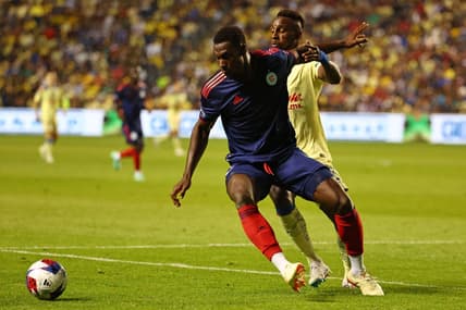 Aug 4, 2023; Bridgeview, IL, USA; Chicago Fire defender Carlos Teran (4) kicks the ball past Club America forward Julian Quinones (33) during the second half at SeatGeek Stadium. Mandatory Credit: Mike Dinovo-USA TODAY Sports