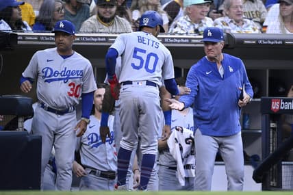 Aug 4, 2023; San Diego, California, USA; Los Angeles Dodgers right fielder Mookie Betts (50) is congratulated at the dugout after scoring a run against the San Diego Padres during the fifth inning at Petco Park. Mandatory Credit: Orlando Ramirez-USA TODAY Sports
