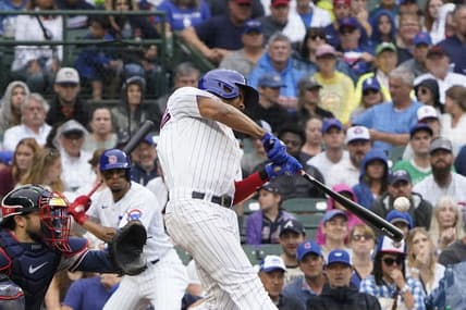 Aug 6, 2023; Chicago, Illinois, USA; Chicago Cubs first baseman Jeimer Candelario (9) hits a one run single against the Atlanta Braves during the fifth inning at Wrigley Field. Mandatory Credit: David Banks-USA TODAY Sports