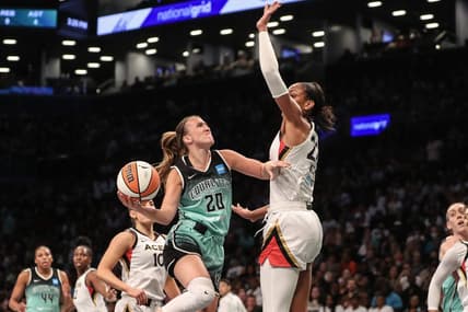 Aug 6, 2023; Brooklyn, New York, USA;  New York Liberty guard Sabrina Ionescu (20) looks to drive past Las Vegas Aces forward A'ja Wilson (22) in the first quarter at Barclays Center. Mandatory Credit: Wendell Cruz-USA TODAY Sports