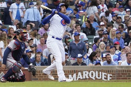 Aug 6, 2023; Chicago, Illinois, USA; Chicago Cubs center fielder Cody Bellinger (24) hits a single against the Atlanta Braves during the seventh inning at Wrigley Field. Mandatory Credit: David Banks-USA TODAY Sports