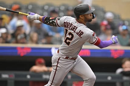 Aug 6, 2023; Minneapolis, Minnesota, USA;  Arizona Diamondbacks outfielder Lourdes Gurriel (12) hits a double against the Minnesota Twins during the seventh inning at Target Field. Mandatory Credit: Nick Wosika-USA TODAY Sports