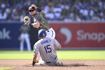 Aug 6, 2023; San Diego, California, USA; San Diego Padres second baseman Jake Cronenworth (9) forces out Los Angeles Dodgers catcher Austin Barnes (15) at second base during the third inning at Petco Park. Mandatory Credit: Orlando Ramirez-USA TODAY Sports