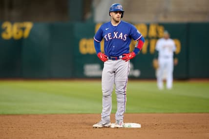 Aug 7, 2023; Oakland, California, USA; Texas Rangers catcher Mitch Garver (18) stands on second base after hitting his second double of the game against the Oakland Athletics during the sixth inning at Oakland-Alameda County Coliseum. Mandatory Credit: Robert Edwards-USA TODAY Sports