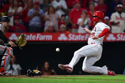 Aug 7, 2023; Anaheim, California, USA; Los Angeles Angels first baseman C.J. Cron scores a run against San Francisco Giants catcher Patrick Bailey (14) during the sixth inning at Angel Stadium. Mandatory Credit: Gary A. Vasquez-USA TODAY Sports