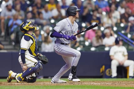 Aug 8, 2023; Milwaukee, Wisconsin, USA;  Colorado Rockies left fielder Nolan Jones (22) hits a sacrifice fly ball during the tenth inning against the Milwaukee Brewers at American Family Field. Mandatory Credit: Jeff Hanisch-USA TODAY Sports