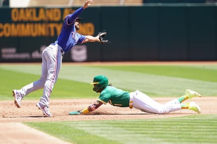 Aug 9, 2023; Oakland, California, USA; Oakland Athletics center fielder Esteury Ruiz (1) steals second base against Texas Rangers second baseman Marcus Semien (2) in the third inning at Oakland-Alameda County Coliseum. Mandatory Credit: Cary Edmondson-USA TODAY Sports