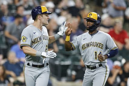 Aug 12, 2023; Chicago, Illinois, USA; Milwaukee Brewers second baseman Andruw Monasterio (14) celebrates with left fielder Mark Canha (21) after they both scored against the Chicago White Sox during the seventh inning at Guaranteed Rate Field. Mandatory Credit: Kamil Krzaczynski-USA TODAY Sports