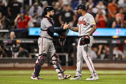 Aug 12, 2023; New York City, New York, USA; Atlanta Braves catcher Travis d'Arnaud (16) and Atlanta Braves relief pitcher Raisel Iglesias (26) shake hands after winning 6-0 against the New York Mets at Citi Field. Mandatory Credit: John Jones-USA TODAY Sports