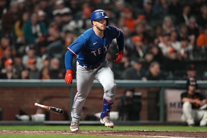 Aug 12, 2023; San Francisco, California, USA; Texas Rangers catcher Mitch Garver (18) runs to first base after hitting an RBI single against the San Francisco Giants during the ninth inning at Oracle Park. Mandatory Credit: Darren Yamashita-USA TODAY Sports