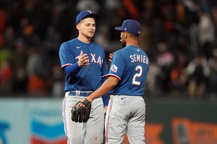 Aug 12, 2023; San Francisco, California, USA; Texas Rangers shortstop Corey Seager (left) celebrates with second baseman Marcus Semien (2) after defeating the San Francisco Giants at Oracle Park. Mandatory Credit: Darren Yamashita-USA TODAY Sports