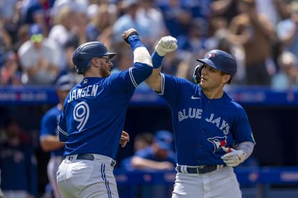 Aug 13, 2023; Toronto, Ontario, CAN; Toronto Blue Jays left fielder Daulton Varsho (25) celebrates hitting a home run against the Chicago Cubs with teammate catcher Danny Jansen (9) during the second inning at Rogers Centre. Mandatory Credit: Kevin Sousa-USA TODAY Sports