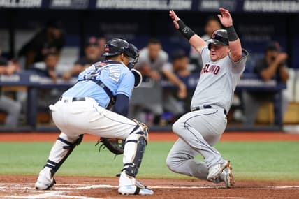 Aug 13, 2023; St. Petersburg, Florida, USA;  Cleveland Guardians first baseman Kole Calhoun (56) scores a run past Tampa Bay Rays catcher Christian Bethancourt (14) in the third inning at Tropicana Field. Mandatory Credit: Nathan Ray Seebeck-USA TODAY Sports