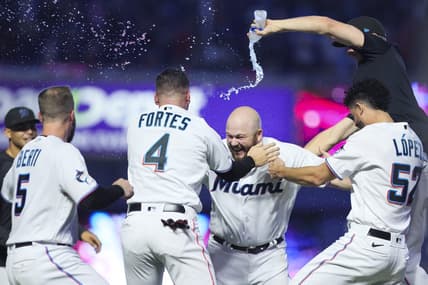 Aug 13, 2023; Miami, Florida, USA; Miami Marlins third baseman Jake Burger (36) celebrates with catcher Nick Fortes (4), relief pitcher Jorge Lopez (52), and shortstop Jon Berti (5) after hitting a walk-off single against the New York Yankees at loanDepot Park. Mandatory Credit: Sam Navarro-USA TODAY Sports