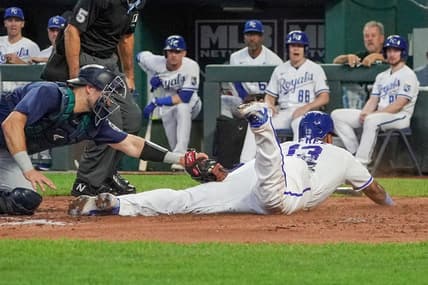 Aug 16, 2023; Kansas City, Missouri, USA; Seattle Mariners catcher Cal Raleigh (29) misses the tag as Kansas City Royals catcher Salvador Perez (13) scores in the third inning at Kauffman Stadium. Mandatory Credit: Denny Medley-USA TODAY Sports