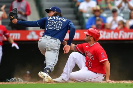 Aug 19, 2023; Anaheim, California, USA; Los Angeles Angels third baseman Mike Moustakas (8) scores a run against Tampa Bay Rays starting pitcher Tyler Glasnow (20) during the third inning at Angel Stadium. Mandatory Credit: Gary A. Vasquez-USA TODAY Sports