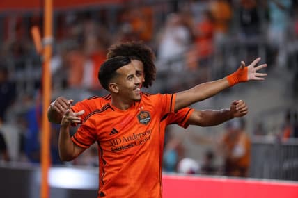Aug 20, 2023; Houston, Texas, USA; Houston Dynamo midfielder Amine Bassi (8) celebrates after scoring a goal with teammate during the first half at Shell Energy Stadium. Mandatory Credit: Thomas Shea-USA TODAY Sports