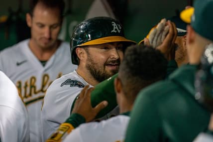 Aug 21, 2023; Oakland, California, USA;  Oakland Athletics catcher Shea Langeliers (23) celebrates with teammates in the dugout after hitting a solo homer against the Kansas City Royals during the sixth inning at Oakland-Alameda County Coliseum. Mandatory Credit: Neville E. Guard-USA TODAY Sports