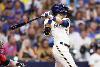 Aug 22, 2023; Milwaukee, Wisconsin, USA;  Milwaukee Brewers left fielder Christian Yelich (22) hits a double during the third inning against the Minnesota Twins at American Family Field. Mandatory Credit: Jeff Hanisch-USA TODAY Sports