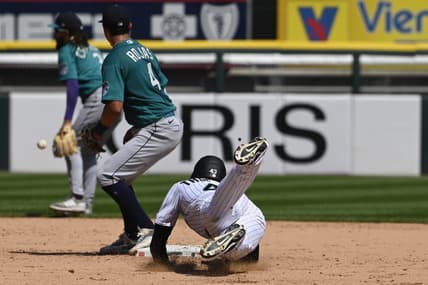 Aug 23, 2023; Chicago, Illinois, USA;  Chicago White Sox center fielder Trayce Thompson (43) slides into second base after hitting a double as Seattle Mariners  second baseman Josh Rojas (4) catches the ball during the fourth inning at Guaranteed Rate Field. Mandatory Credit: Matt Marton-USA TODAY Sports