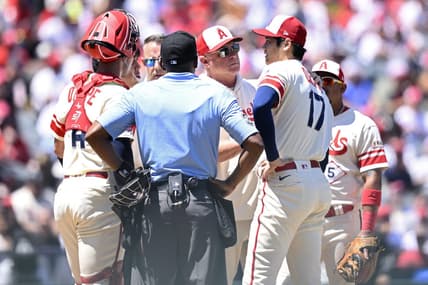 Aug 23, 2023; Anaheim, California, USA; Los Angeles Angels manager Phil Nevin (center) meets with starting pitcher Shohei Ohtani (17) at the mound during the second inning against the Cincinnati Reds at Angel Stadium. Mandatory Credit: Orlando Ramirez-USA TODAY Sports