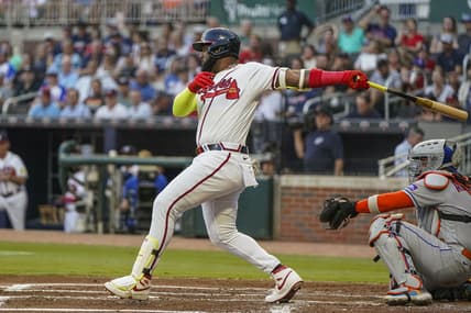 Aug 23, 2023; Cumberland, Georgia, USA; Atlanta Braves designated hitter Marcell Ozuna (20) drives in a run with a single against the New York Mets during the first inning at Truist Park. Mandatory Credit: Dale Zanine-USA TODAY Sports