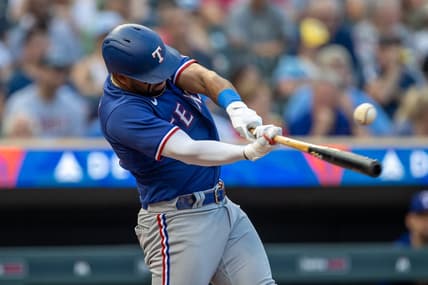Aug 24, 2023; Minneapolis, Minnesota, USA; Texas Rangers third baseman Ezequiel Duran (20) hits a single against the Minnesota Twins in the second inning at Target Field. Mandatory Credit: Jesse Johnson-USA TODAY Sports