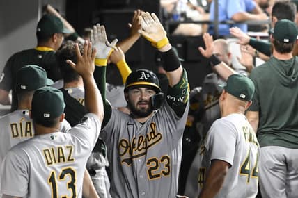 Aug 24, 2023; Chicago, Illinois, USA;  Oakland Athletics catcher Shea Langeliers (23) celebrates in the dugout after he hits a three run homerun against the Chicago White Sox during the fourth inning at Guaranteed Rate Field. Mandatory Credit: Matt Marton-USA TODAY Sports