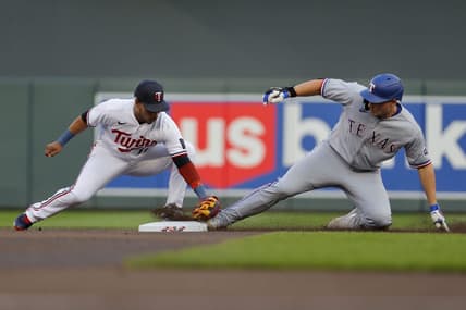 Aug 25, 2023; Minneapolis, Minnesota, USA; Texas Rangers shortstop Corey Seager (5) beats the tag of Minnesota Twins second baseman Jorge Polanco (11) for a double in the first inning at Target Field. Mandatory Credit: Bruce Kluckhohn-USA TODAY Sports