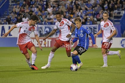 Aug 26, 2023; Montreal, Quebec, CAN; CF Montreal midfielder Bryce Duke (10) dribbles the ball around New England Revolution midfielder Mark-Anthony Kaye (28) and midfielder Ian Harkes (14) during the first half at Stade Saputo. Mandatory Credit: Eric Bolte-USA TODAY Sports