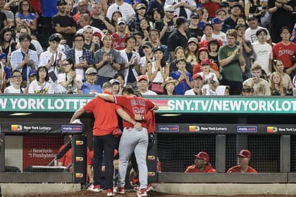 Aug 26, 2023; New York City, New York, USA;  Los Angeles Angels starting pitcher Chase Silseth (63) is helped back into the dugout after getting hit in the head by a throw in the fourth inning against the New York Mets at Citi Field. Mandatory Credit: Wendell Cruz-USA TODAY Sports