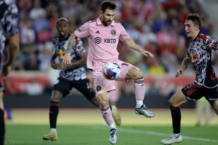 Aug 26, 2023; Harrison, New Jersey, USA; Inter Miami CF forward Lionel Messi (10) controls the ball against New York Red Bulls defender Andres Reyes (4) and midfielder Peter Stroud (5) during the second half at Red Bull Arena. Mandatory Credit: Brad Penner-USA TODAY Sports